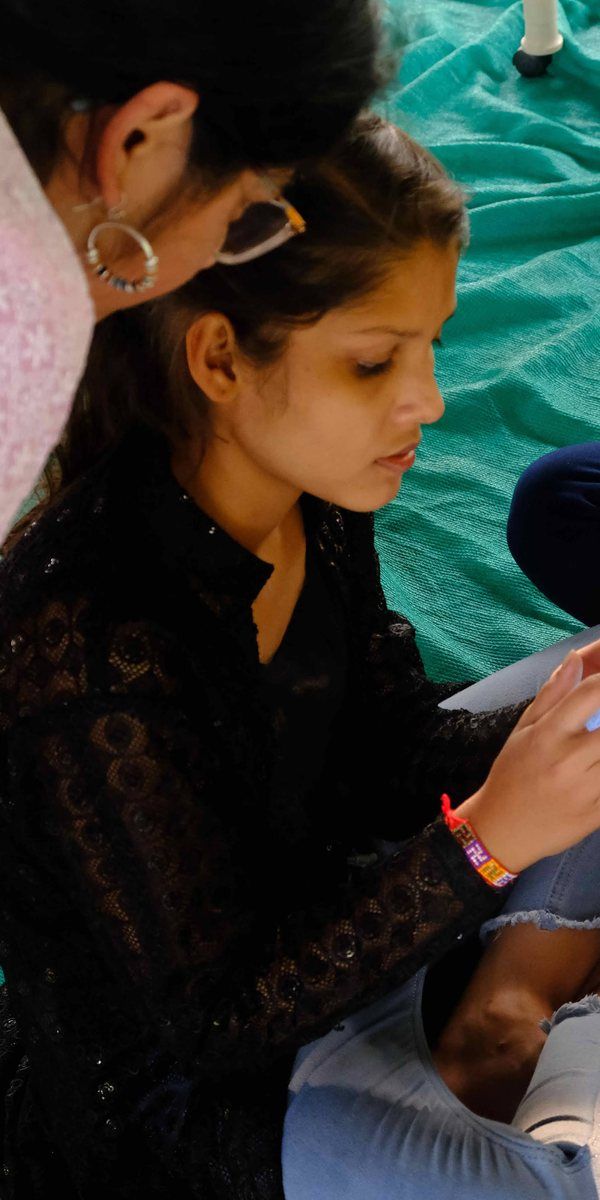 Shalini writing up her project at a workshop